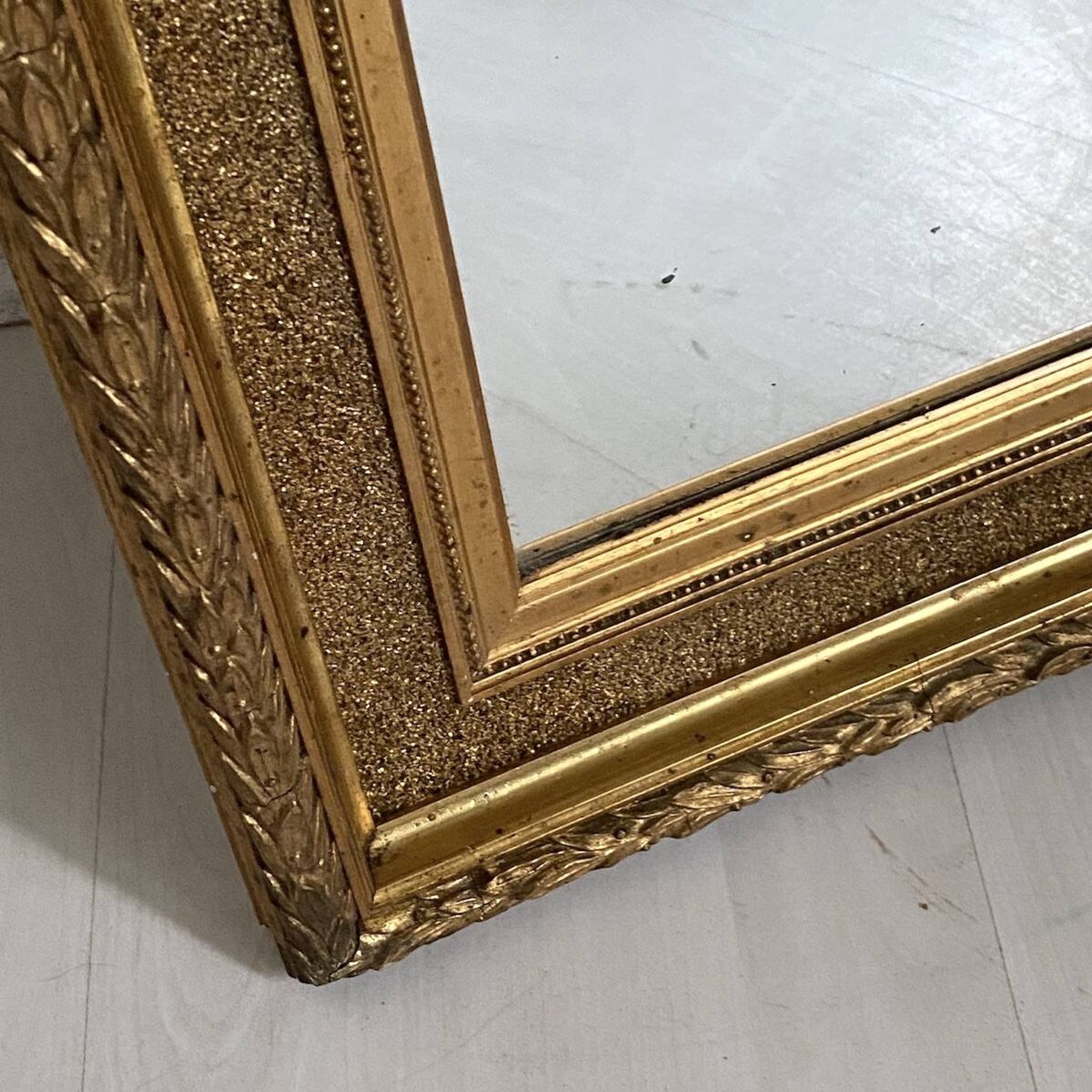 Small wooden mirror with gilded stucco in the Louis XVI style.