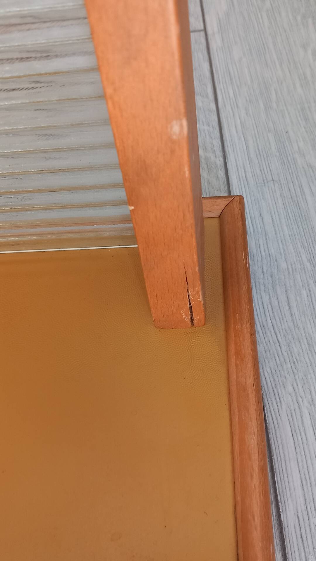 1950s coat rack with mirror, metal hooks, and glass shelf.