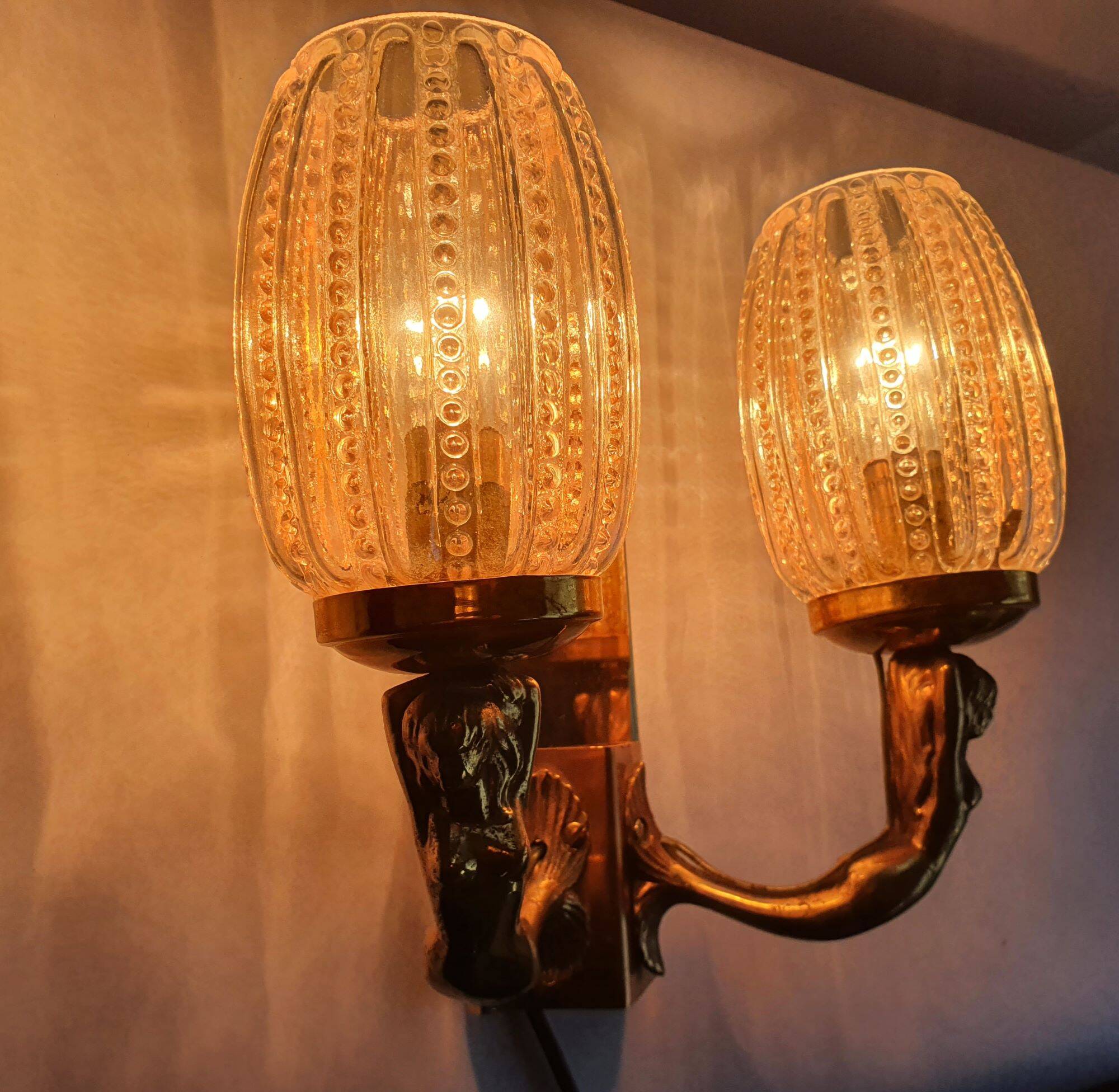 Golden bronze wall lamp with mermaids for an old bathroom.