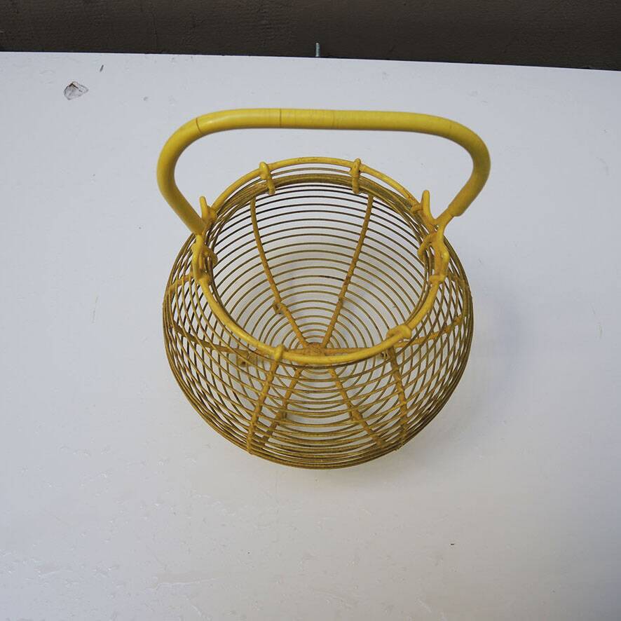 Old yellow painted metal egg basket