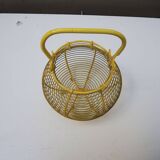 Old yellow painted metal egg basket