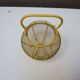 Old yellow painted metal egg basket