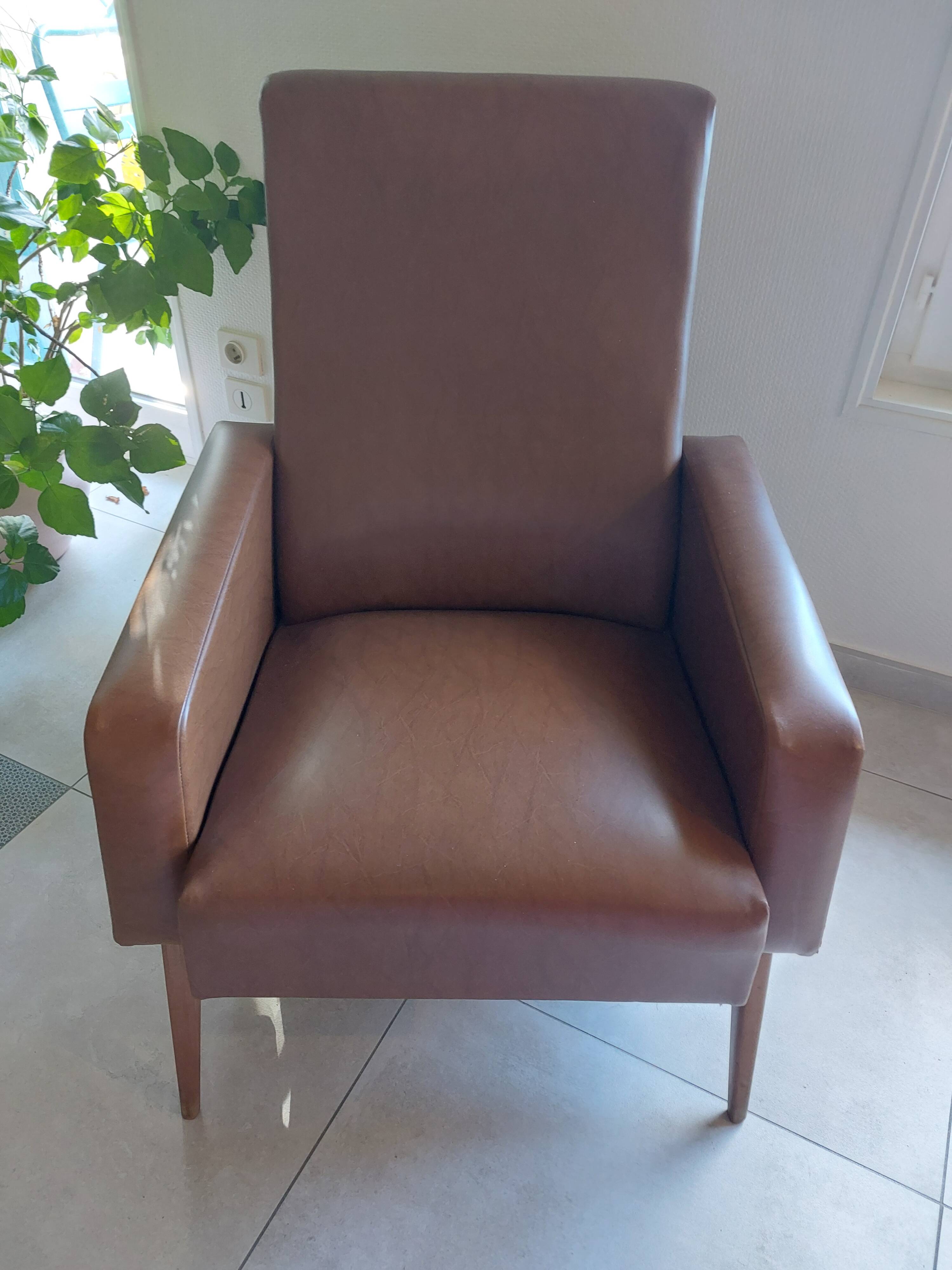 a pair of comfortable vintage armchairs with splayed legs