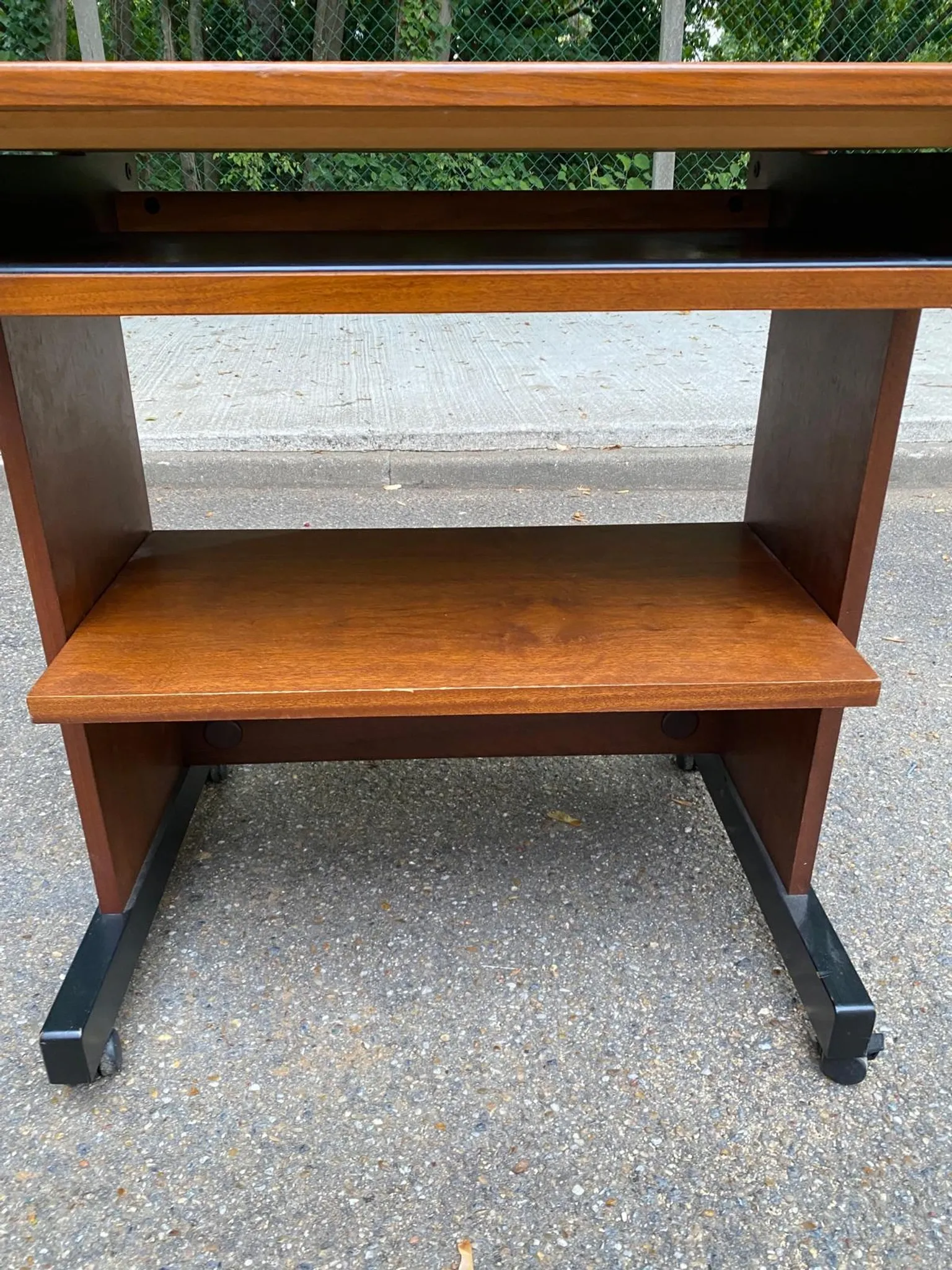 Small Scandinavian-style computer desk on wheels made of wood.