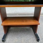 Small Scandinavian-style computer desk on wheels made of wood.
