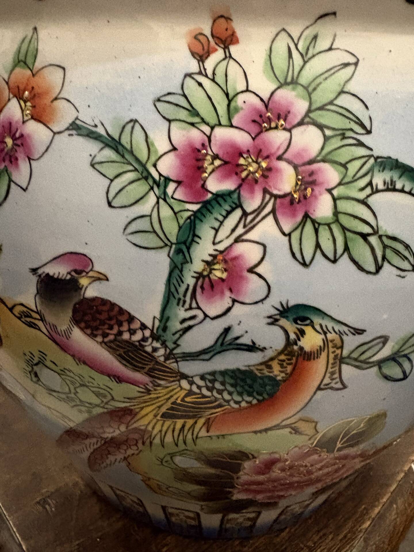 Antique porcelain vase with floral and bird decoration.