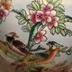 Antique porcelain vase with floral and bird decoration.