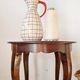 Vintage solid wood side table with curved legs.