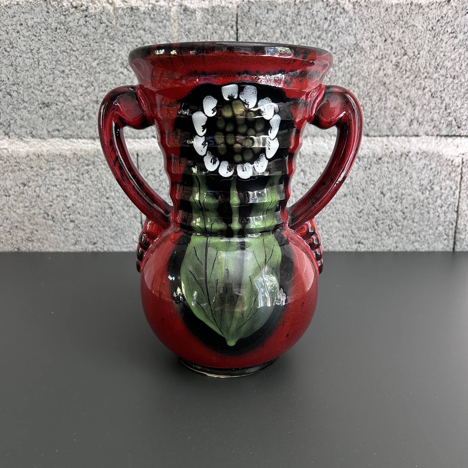 Red vase with floral decoration
