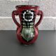 Red vase with floral decoration