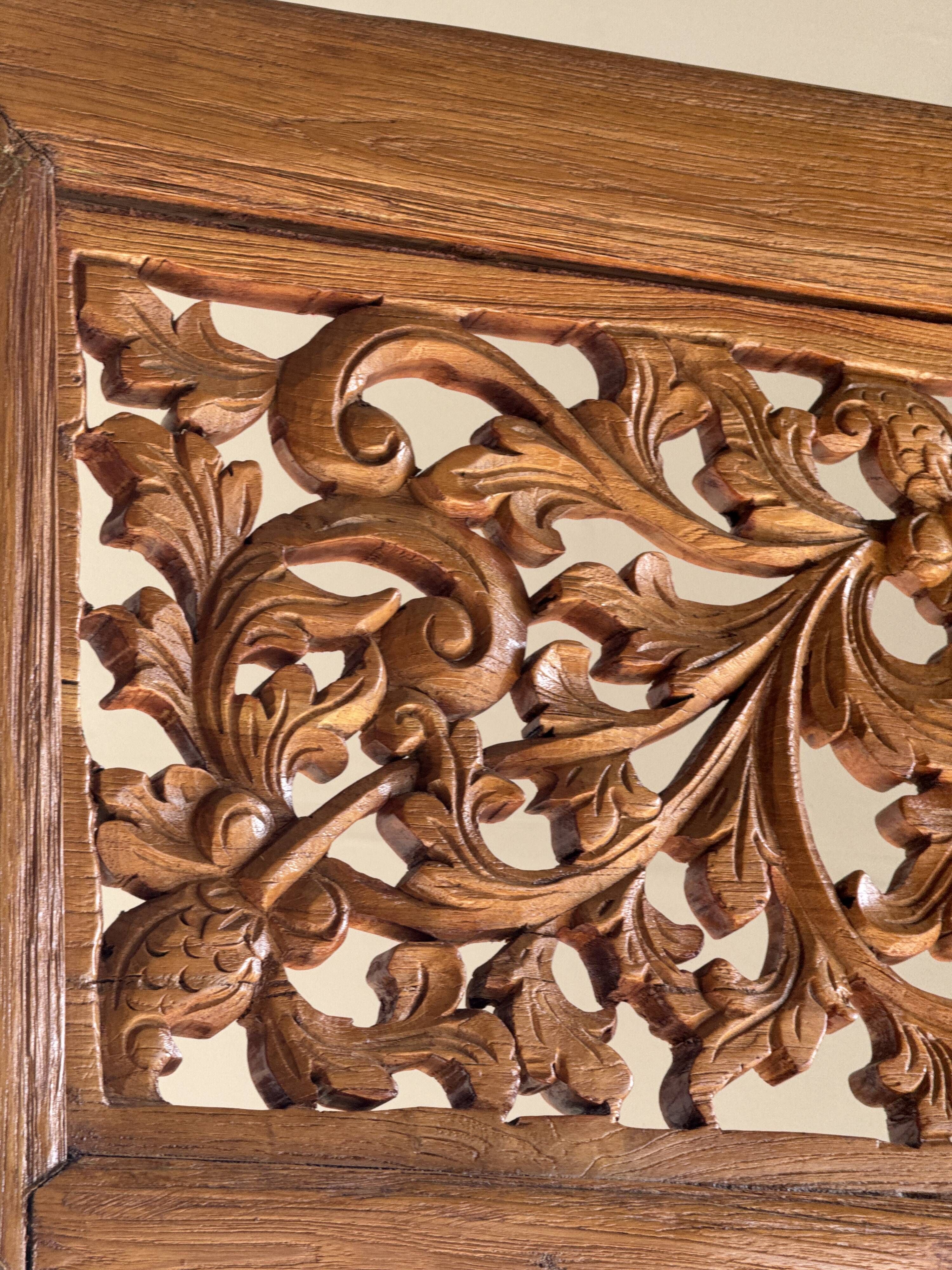 Very large freestanding teak mirror with an openwork carved pediment, Indonesia.