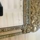 Small mirror with repoussé brass frame.