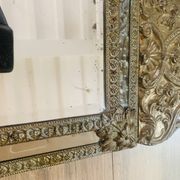 Small mirror with repoussé brass frame.