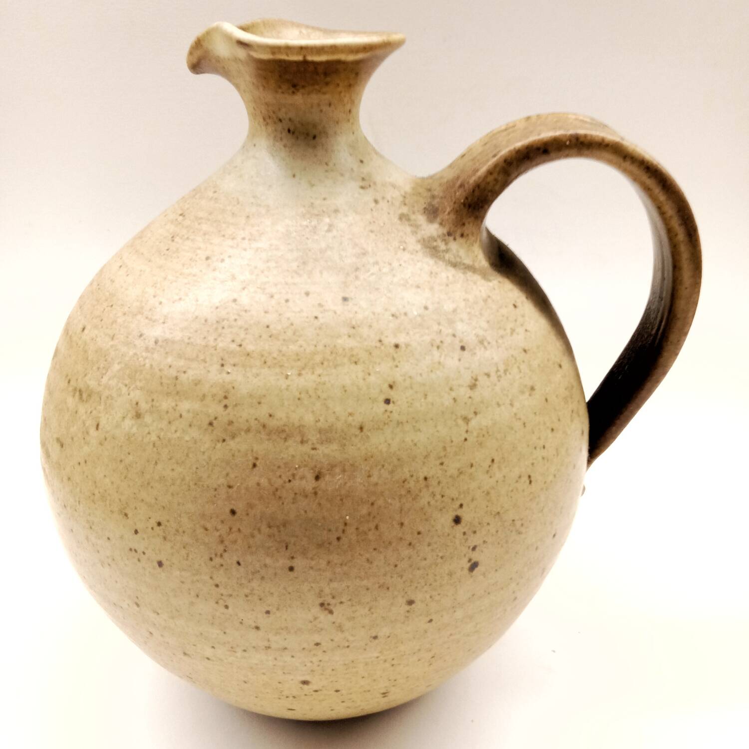 Vintage speckled brown stoneware jug in a round shape.