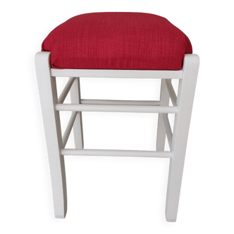 White pine stool with a red seat.