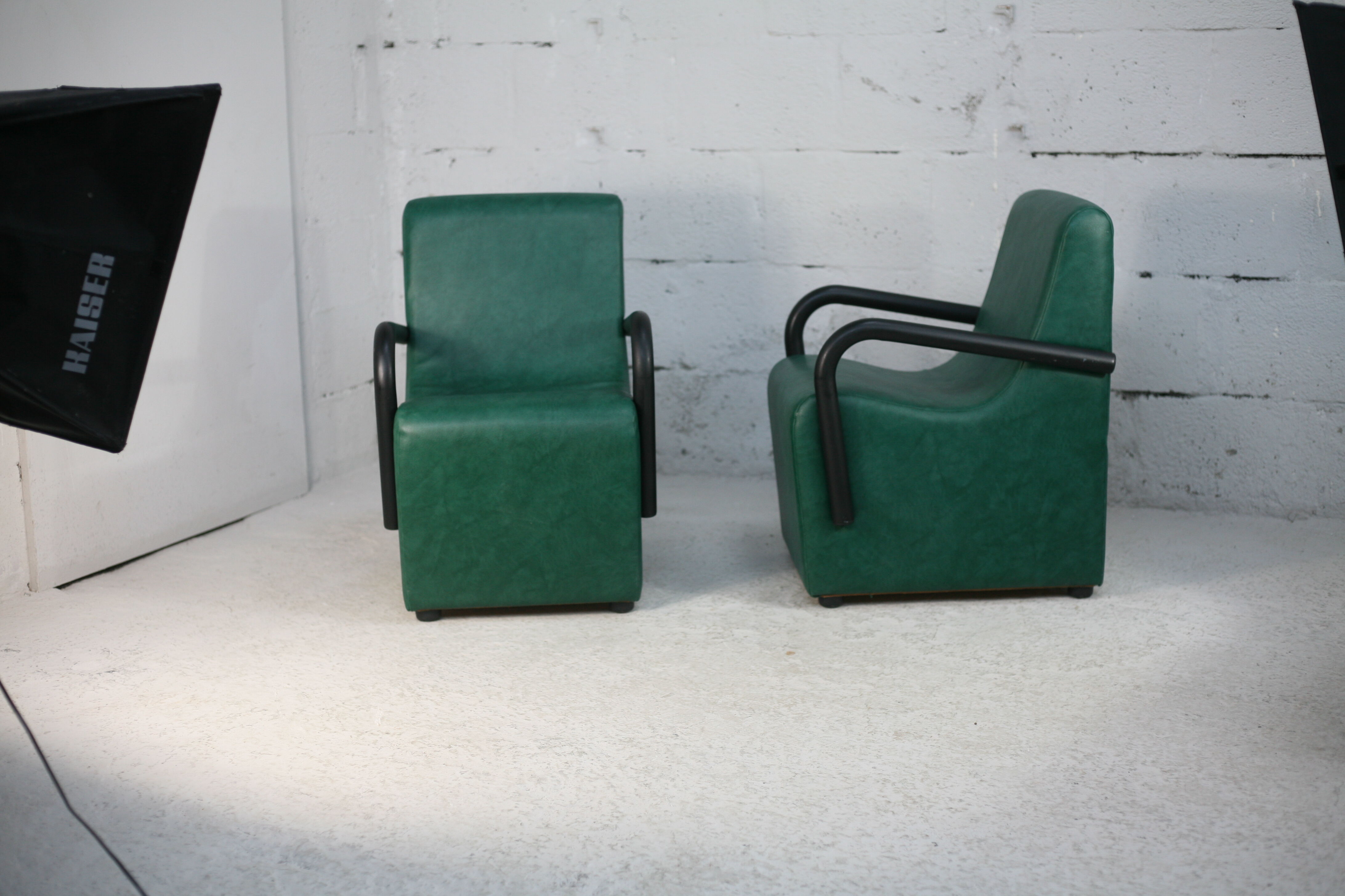 Pair of armrest heaters. Steel and green imitation leather. France, circa 1980