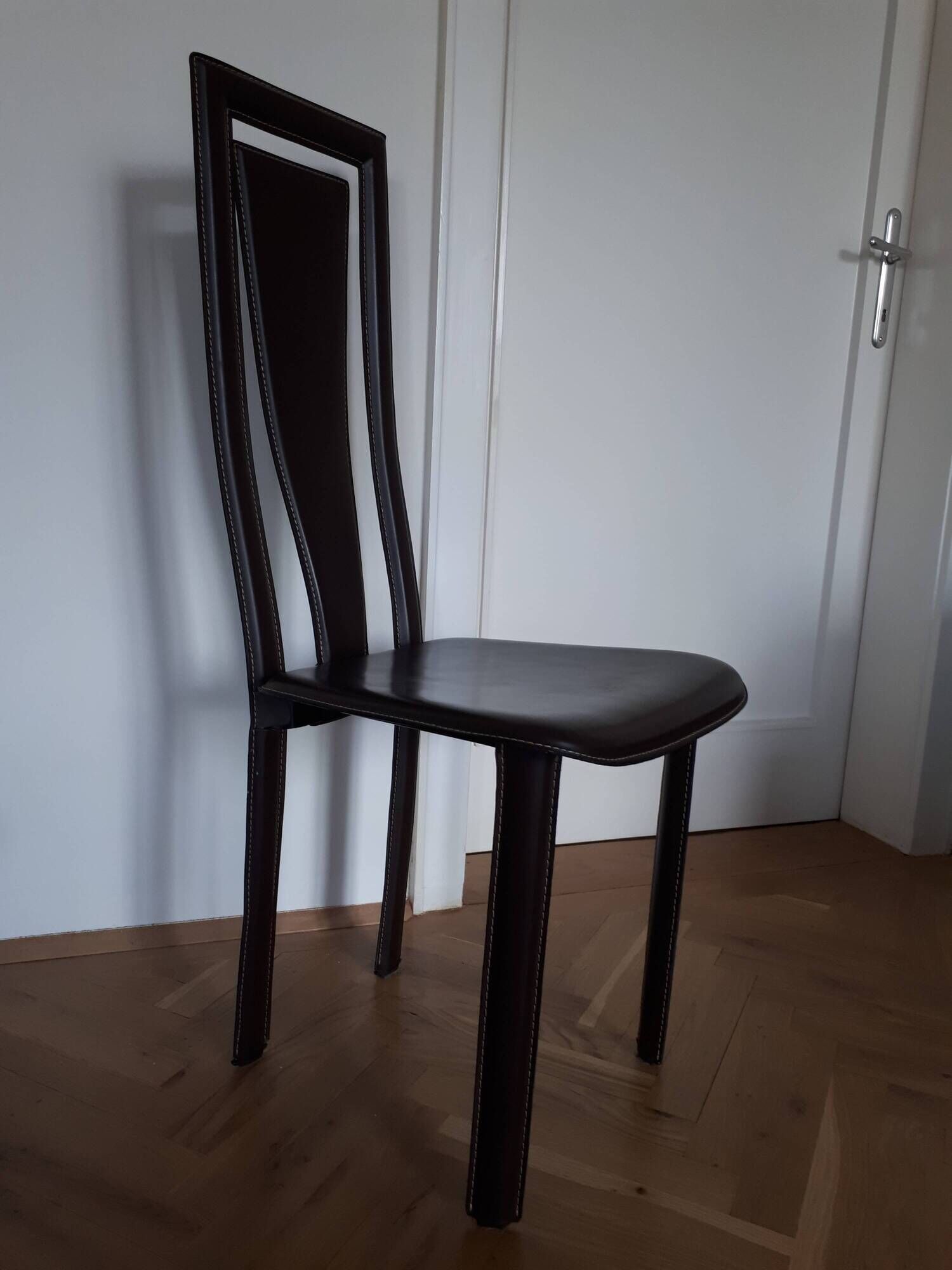 Set of 6 wooden chairs covered in leather.