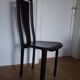 Set of 6 wooden chairs covered in leather.