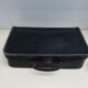 Small suitcase in old navy blue cardboard