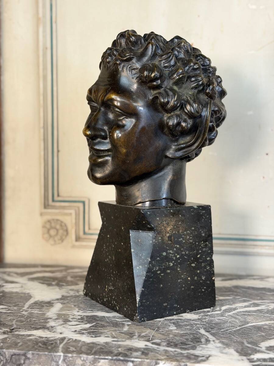 Head of a faun smiling, bronze after the antique, 19th century.