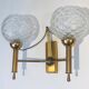 Pair of brass wall lights with glass globes. Around 1970.