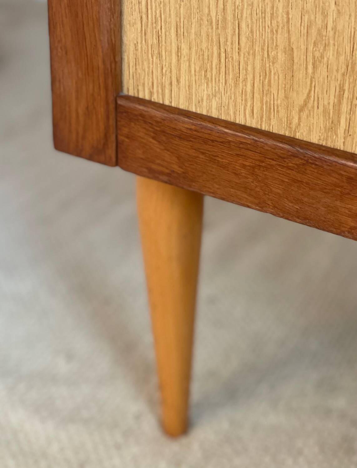 Vintage 1960s chest of drawers with covered handles.