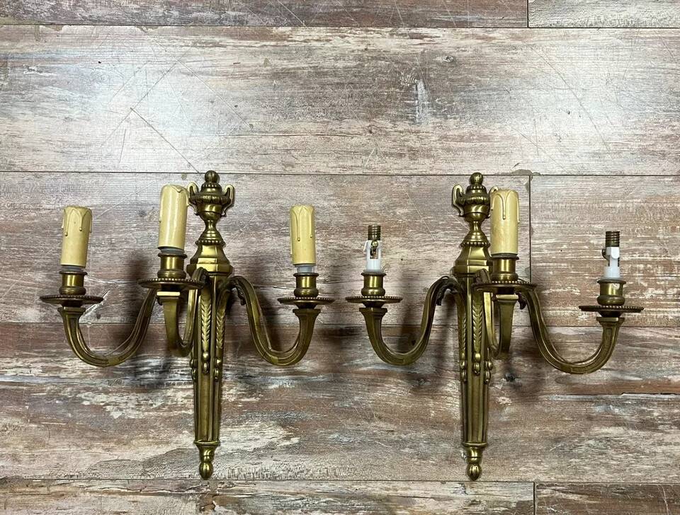 Pair of Louis XVI style gilt bronze wall lights with two light arms, 20th century