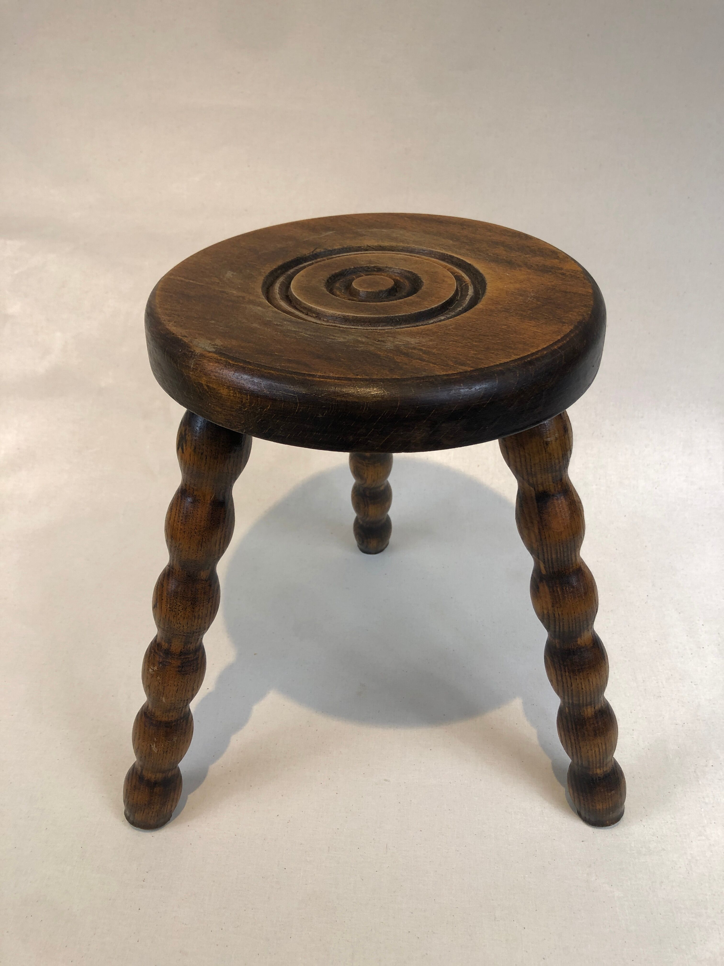 Dark turned wood tripod stool