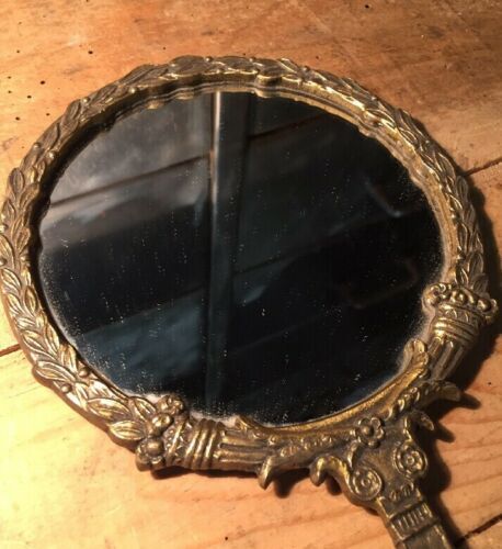 Antique mirror facing round hand in bronze 23cm