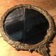 Antique mirror facing round hand in bronze 23cm