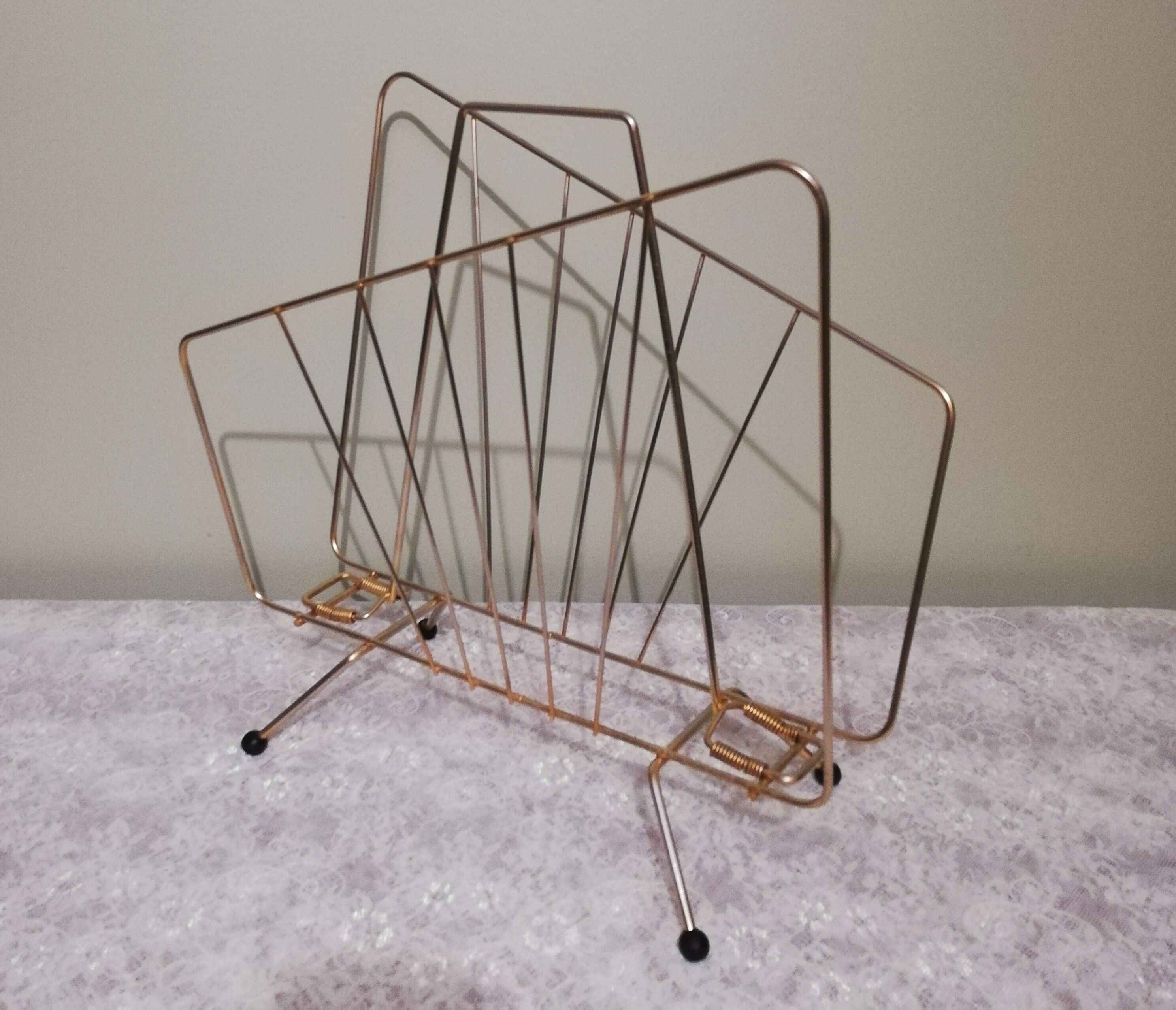 Vintage magazine holder in gilded brass.