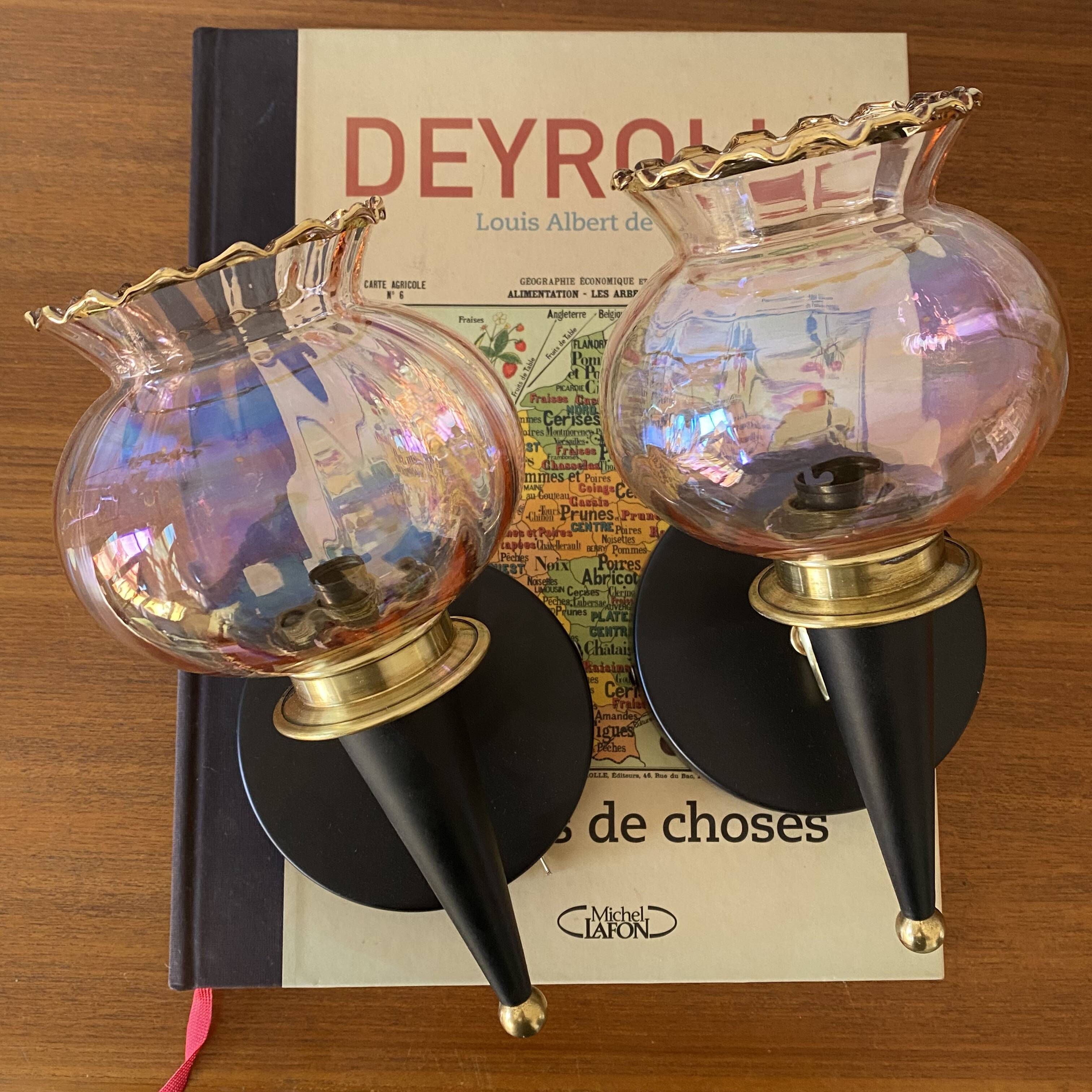 Pair of torch wall lights with iridescent pink glass shades and gold trim.