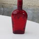 Glass bottle with red glass liqueur, old