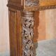 Antique fireplace from around 1880 in solid hand-carved elm with openwork columns.