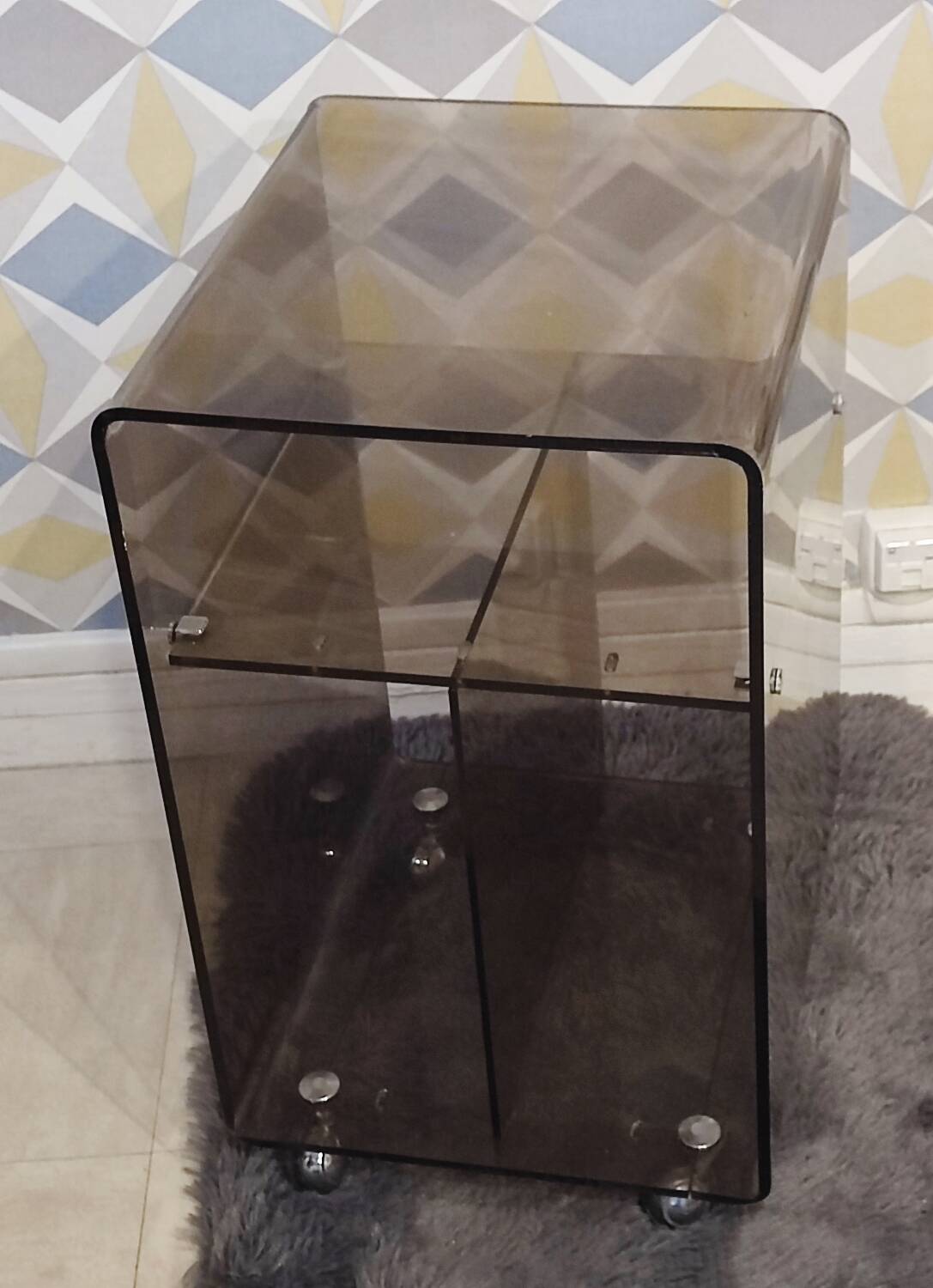 Michel Dumas smoked Plexiglas rolling table.