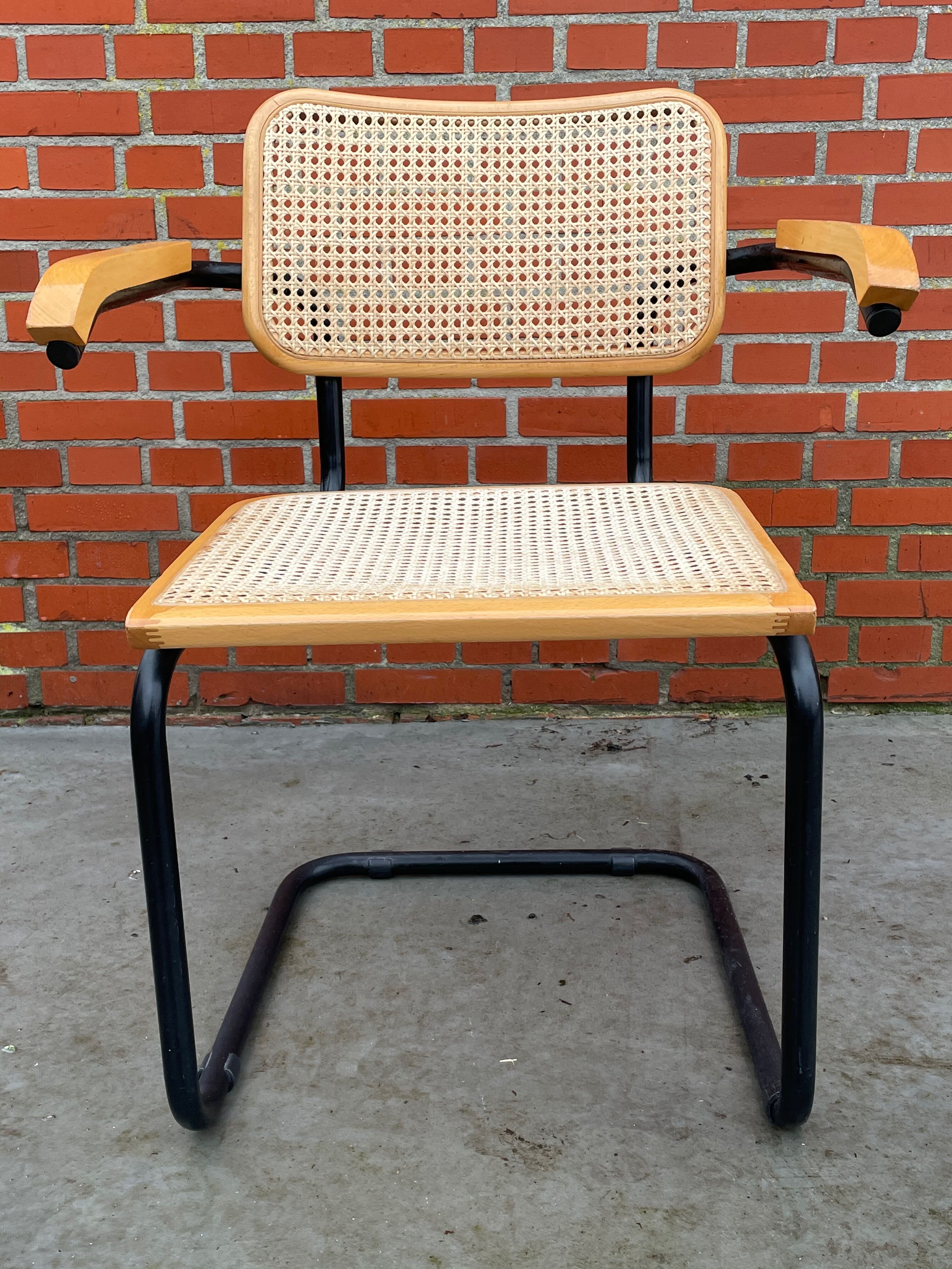 Cesca model chair designed by Marcel Breuer with black-framed armrests