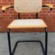 Cesca model chair designed by Marcel Breuer with black-framed armrests