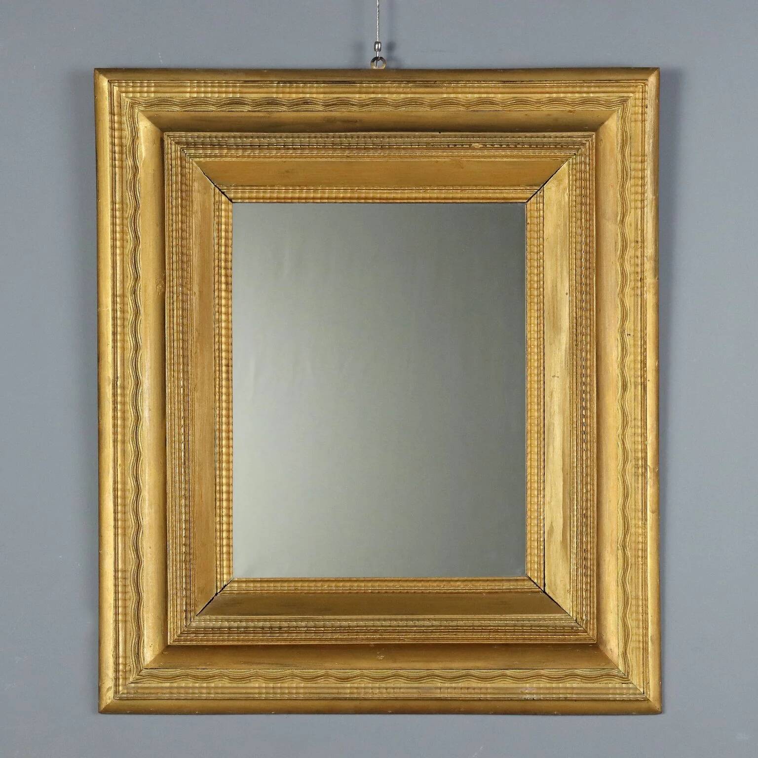 Antique gilded wooden mirror with guilloché frame, Italy, 19th century.