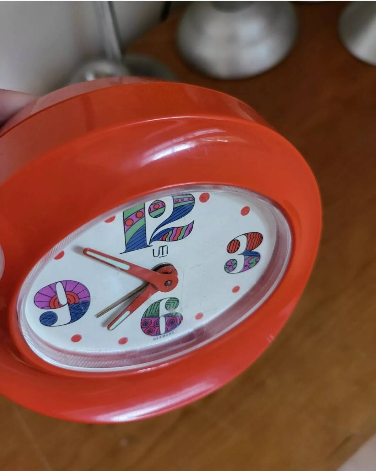 Vintage mechanical alarm clock in orange plastic Uti West Germany