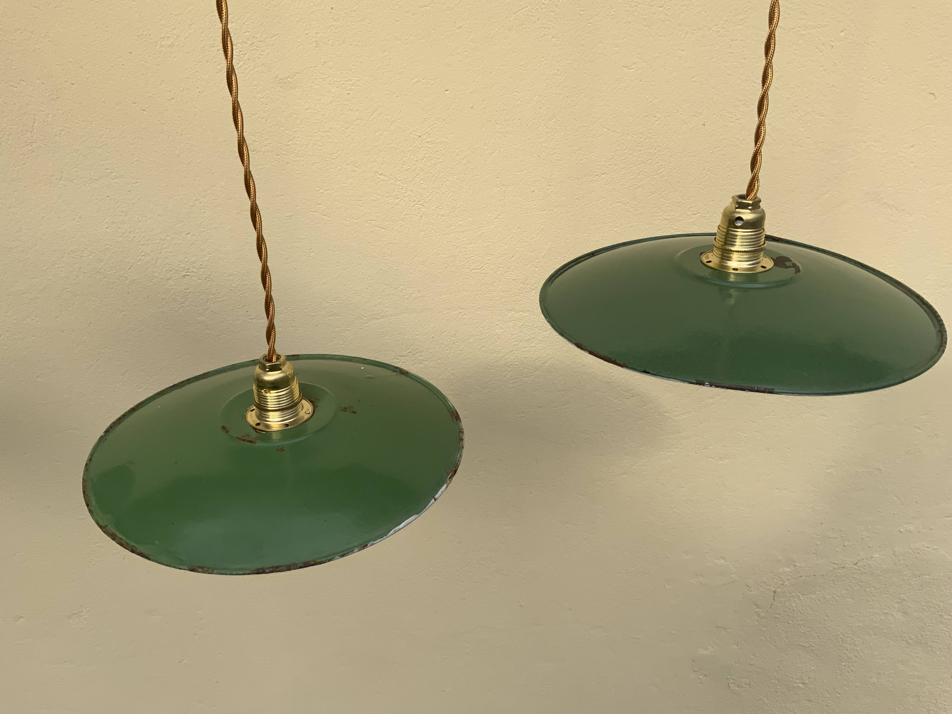 Vintage industrial enameled sheet metal pendant lights with golden wires, old green and white lampshade