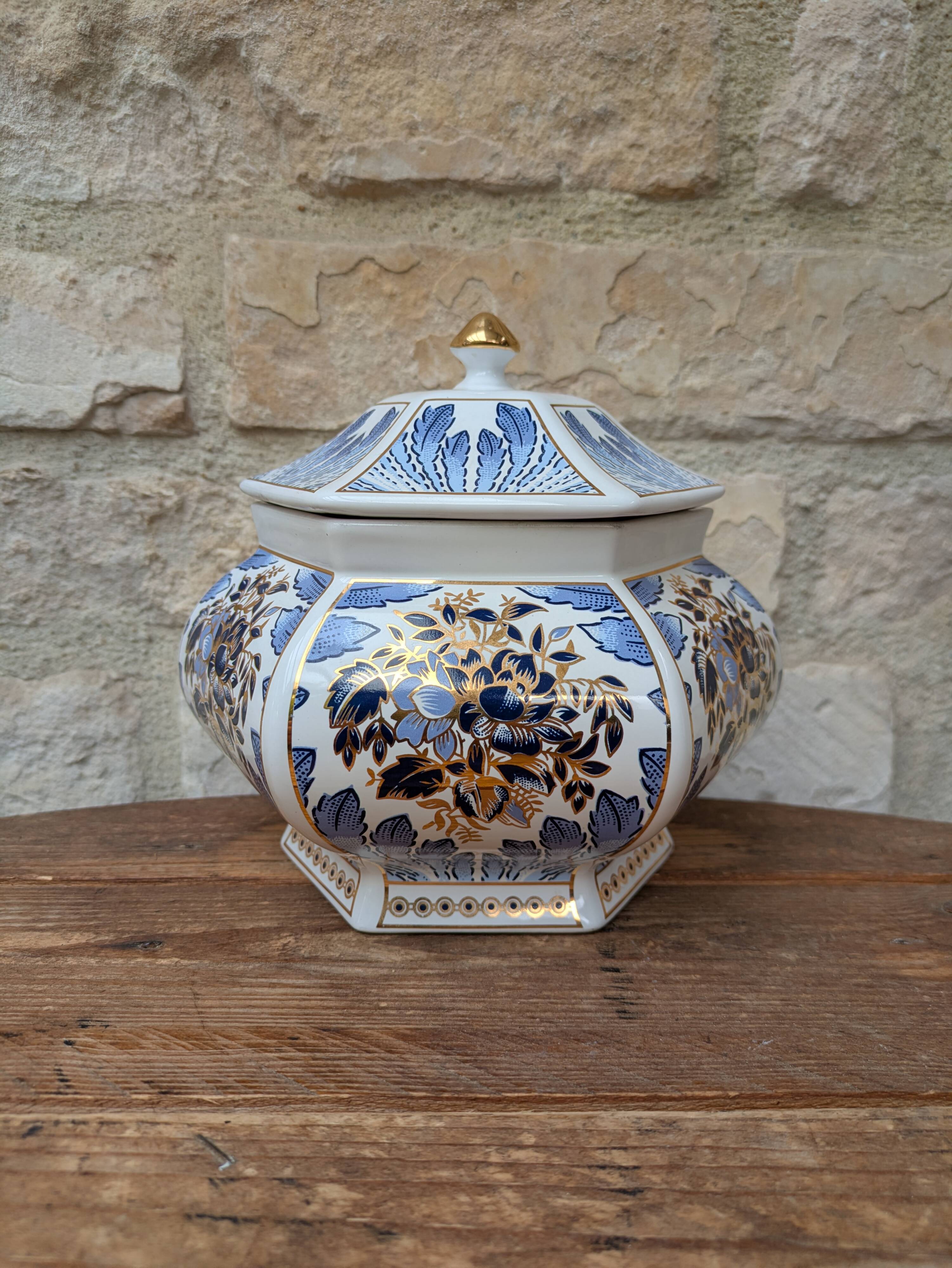 Decorative pot jar with a lid featuring a blue floral pattern and gilding.
