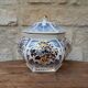 Decorative pot jar with a lid featuring a blue floral pattern and gilding.