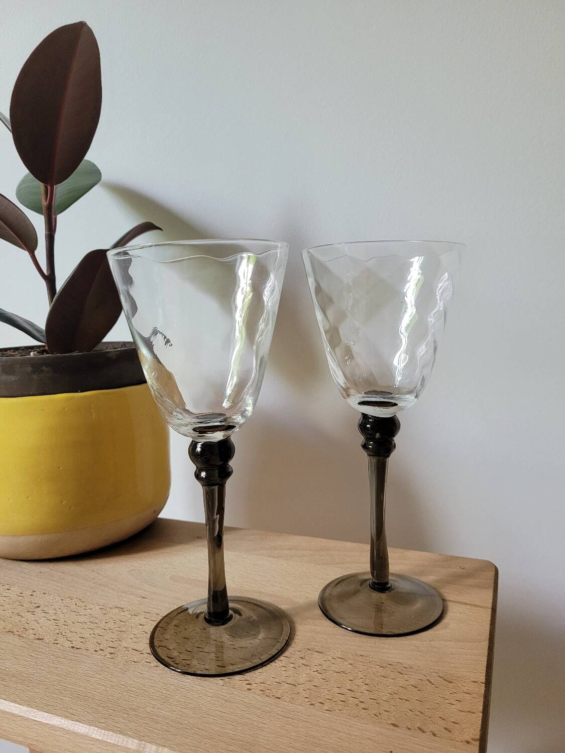 Two smoked black stem wine glasses