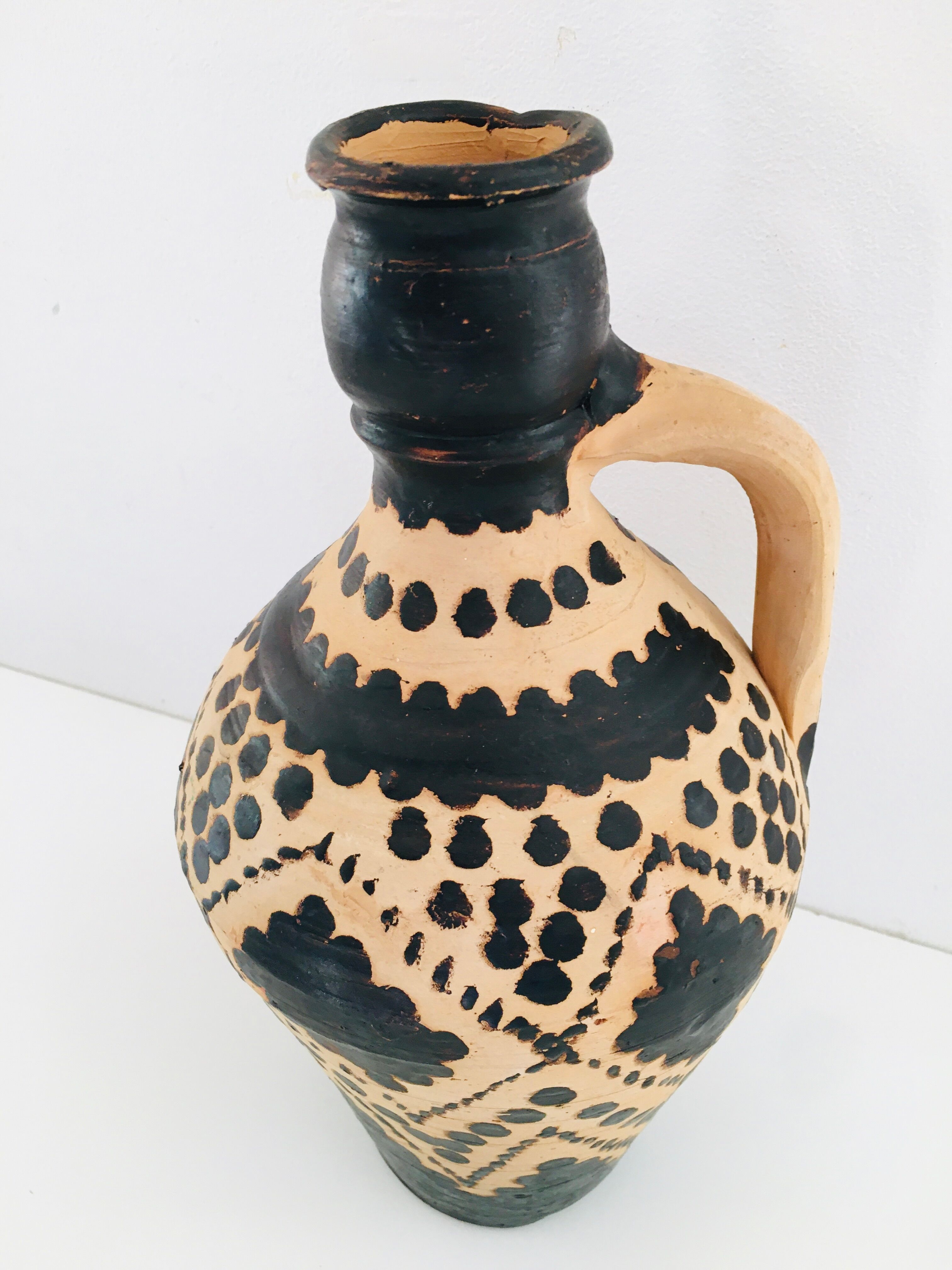 Raw and black terracotta jug