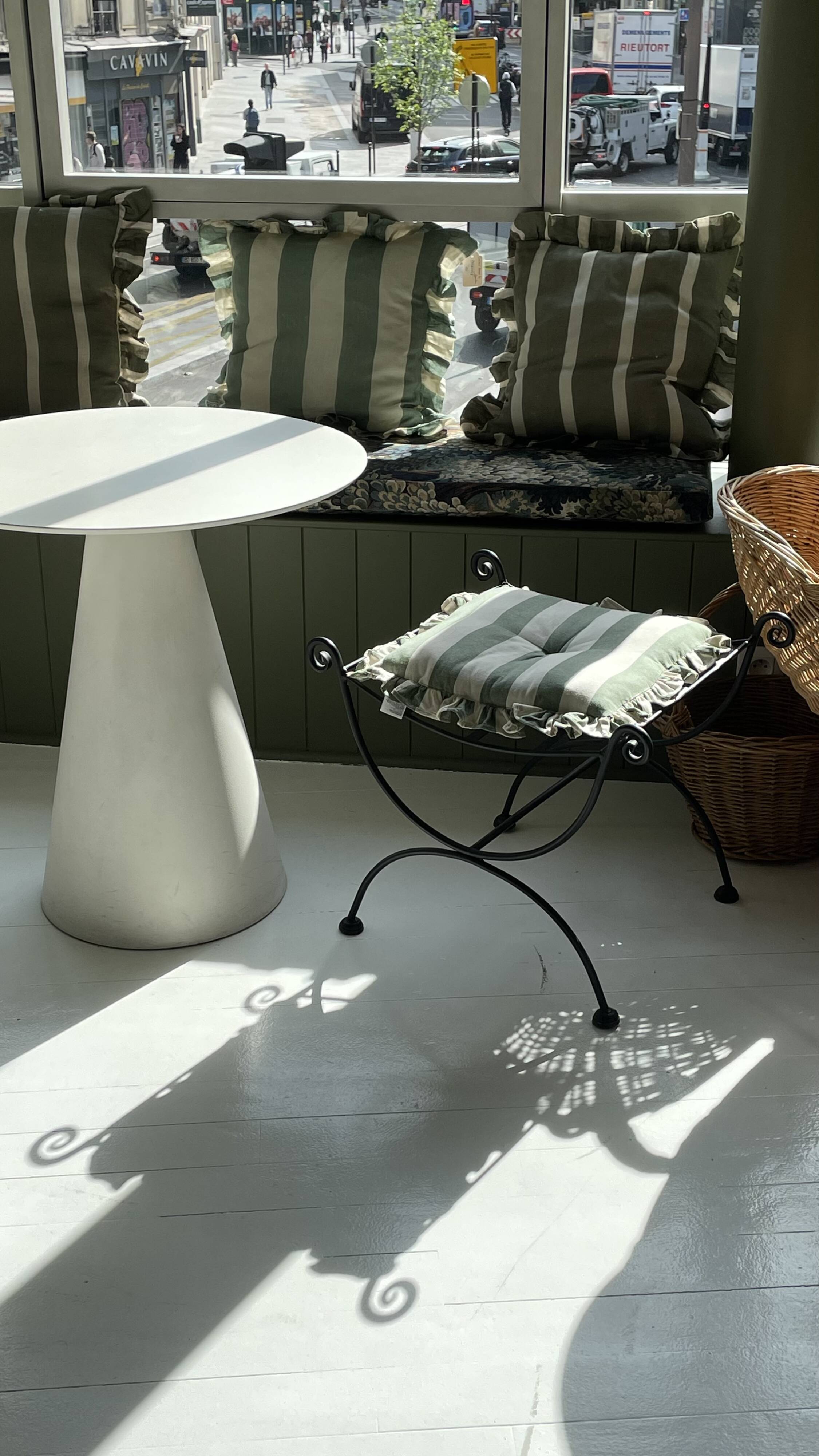 pair of wrought iron stools with cushions