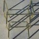 Nested table in gold metal and glass