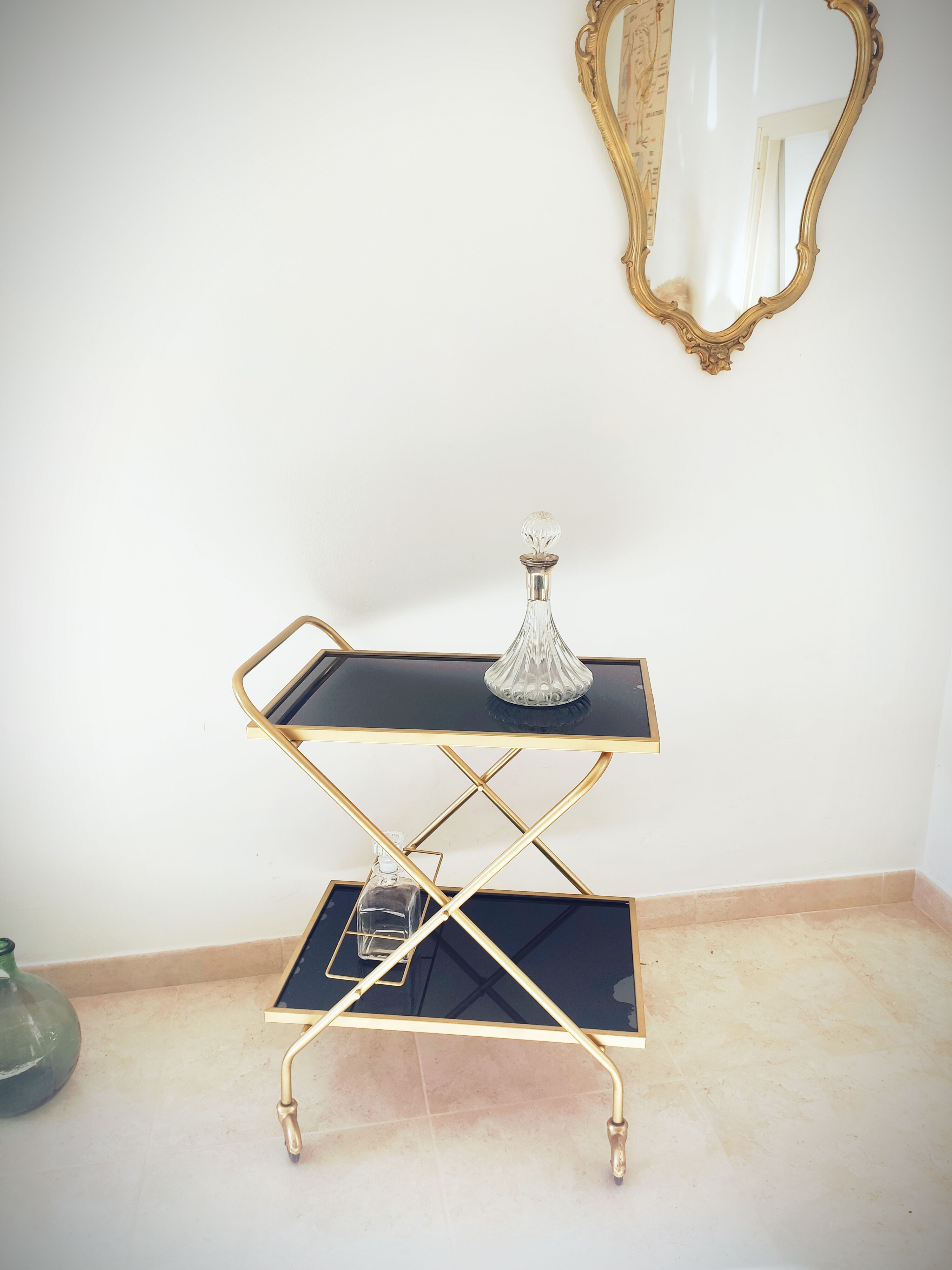 Golden dessert on wheels with black glass trays