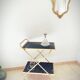 Golden dessert on wheels with black glass trays