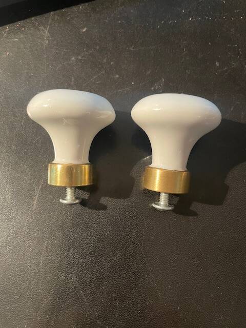 a pair of small antique porcelain and brass knob handles