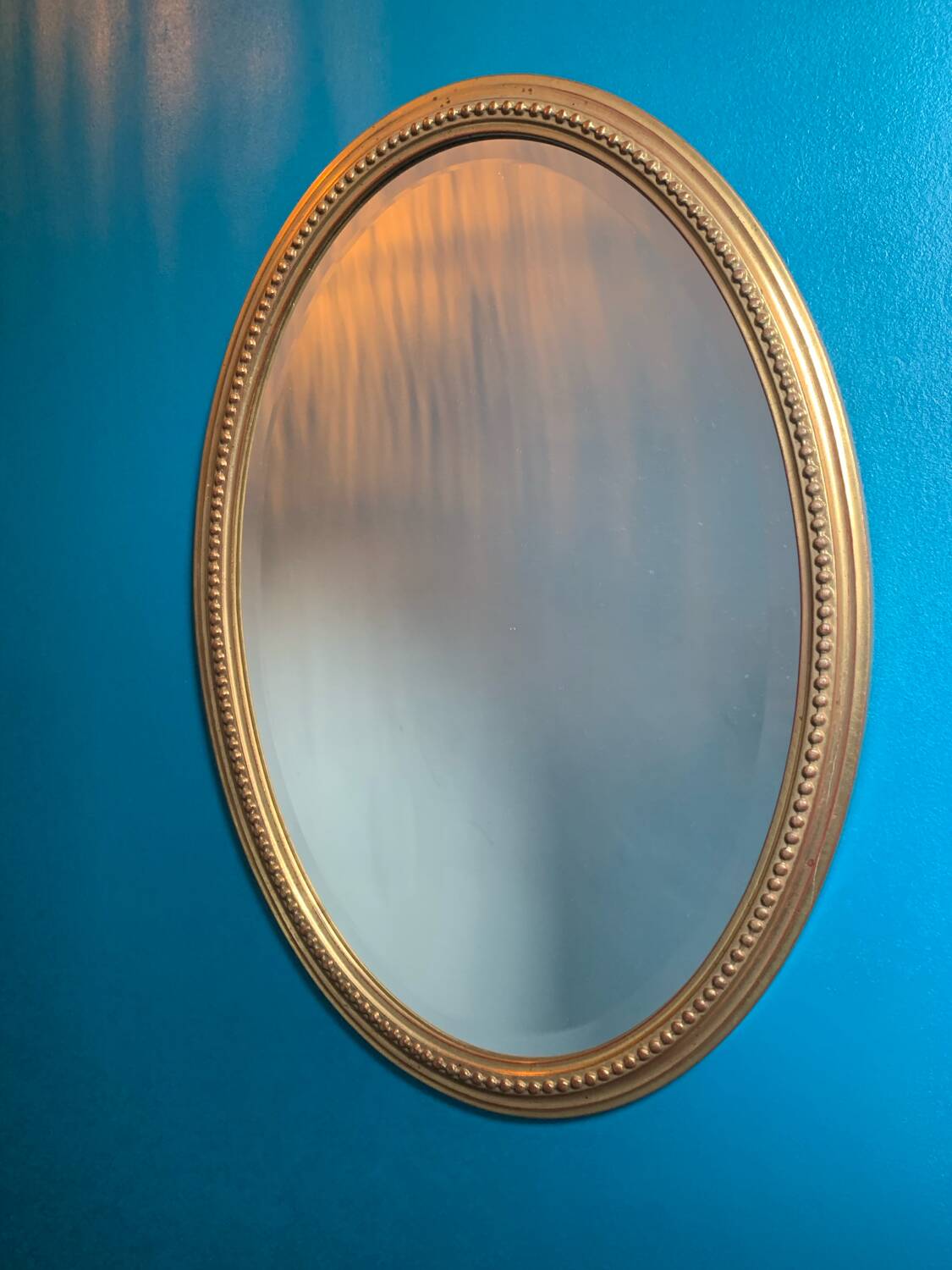 Vintage beveled gold oval mirror
